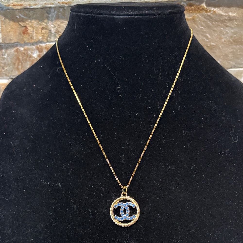 Gold-Tone Necklace with Designer Blue Crystal Interlocking Logo Pendant